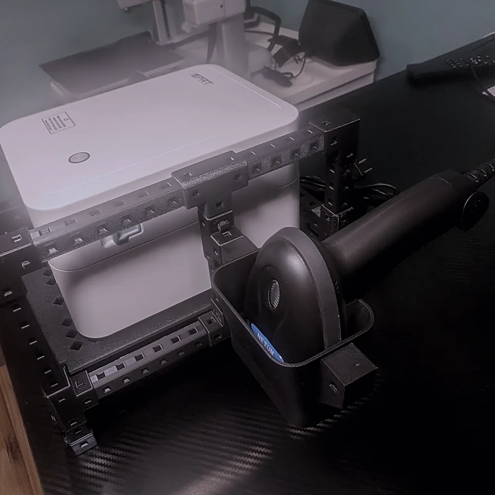 Close-up of the hands-free barcode scanner resting in its 3D-printed cup on the rack.