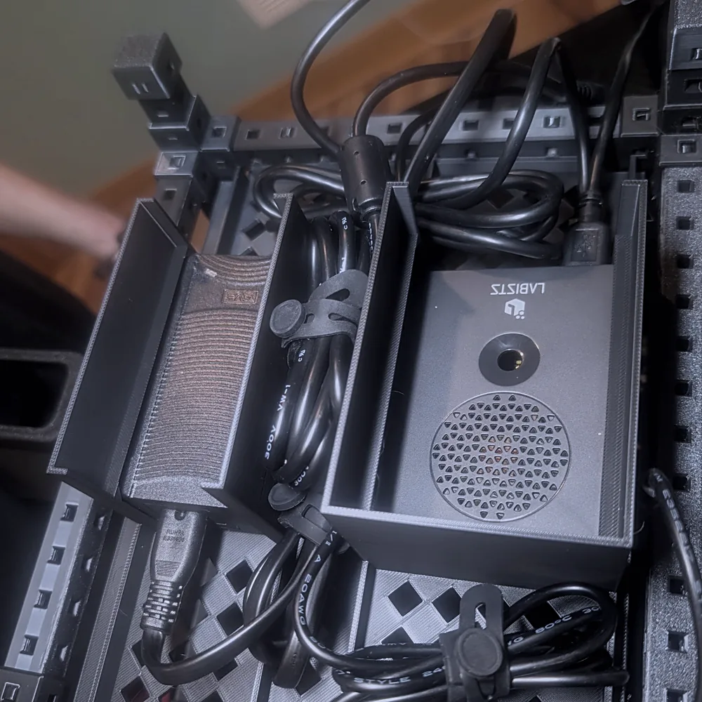 Under the shelf: the small Raspberry Pi computer and power supply tucked into the rack with cables routed.